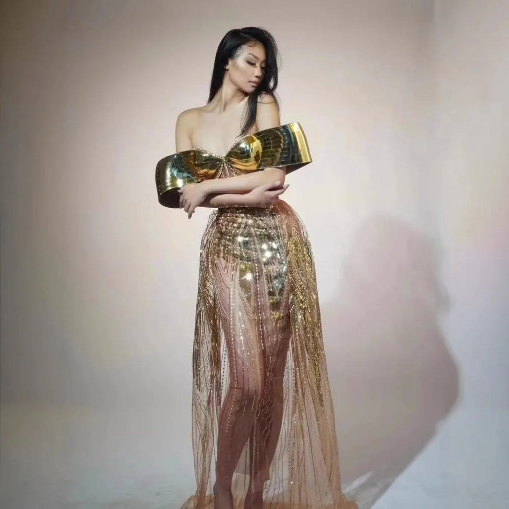 Gold strapless sequined evening dress with a long tulle skirt and a high side split.