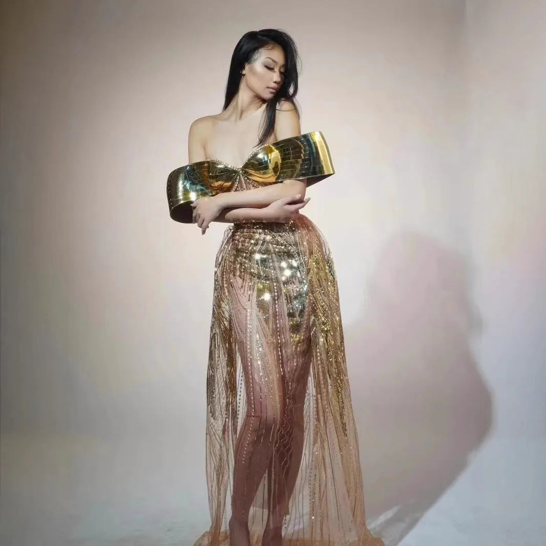 Gold strapless sequined evening dress with a long tulle skirt and a high side split.