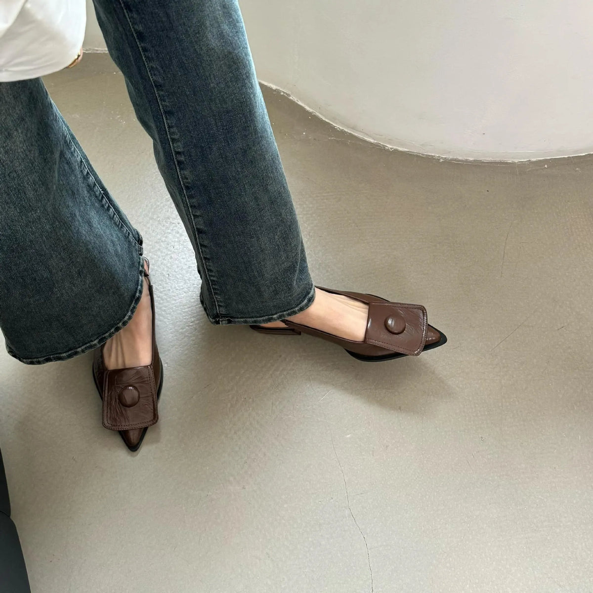 Women's low heel closed toe sandals in apricot with a pointed toe and back strap.