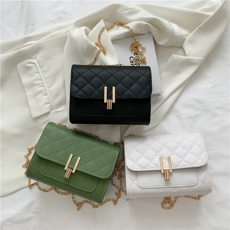 Women's black PU leather crossbody bag with diamond lattice chain detailing and adjustable shoulder strap