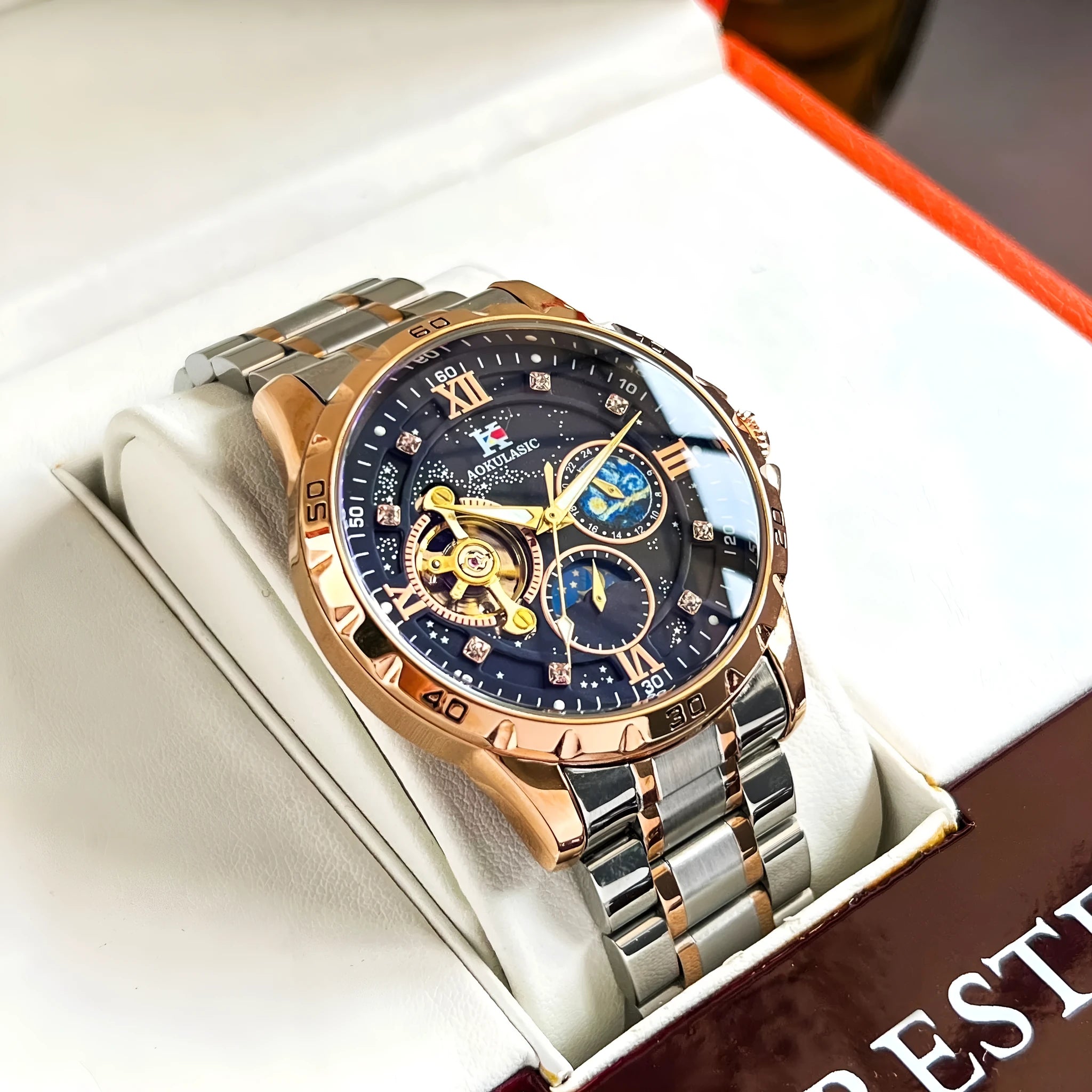 Automatic mechanical men's watch with large black dial and rose gold case, showing 12mm thickness.