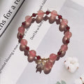Handmade strawberry quartz crystal bracelet with a choice of moon, XINGX, or pearl charm on a natural crystal band.