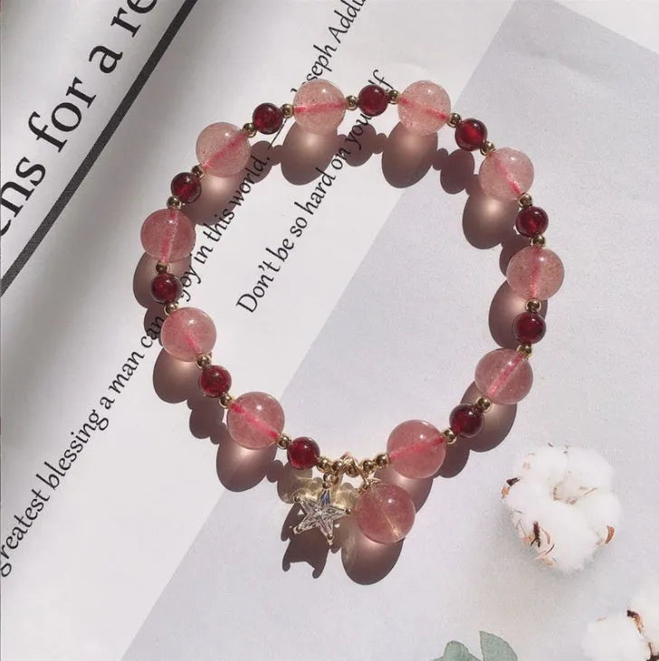 Handmade strawberry quartz crystal bracelet with a choice of moon, XINGX, or pearl charm on a natural crystal band.