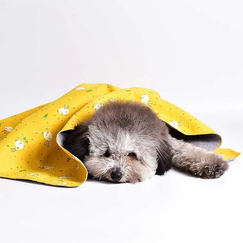 Double-sided cotton fleece pet blanket showing dinosaur print design, folded to show soft texture.