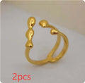 Gold and silver brass opening ring with sphere circle design on a woman's hand.