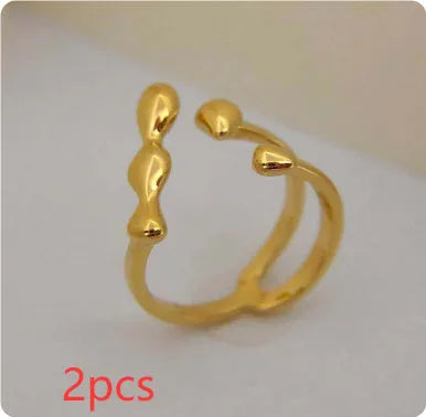 Gold and silver brass opening ring with sphere circle design on a woman's hand.
