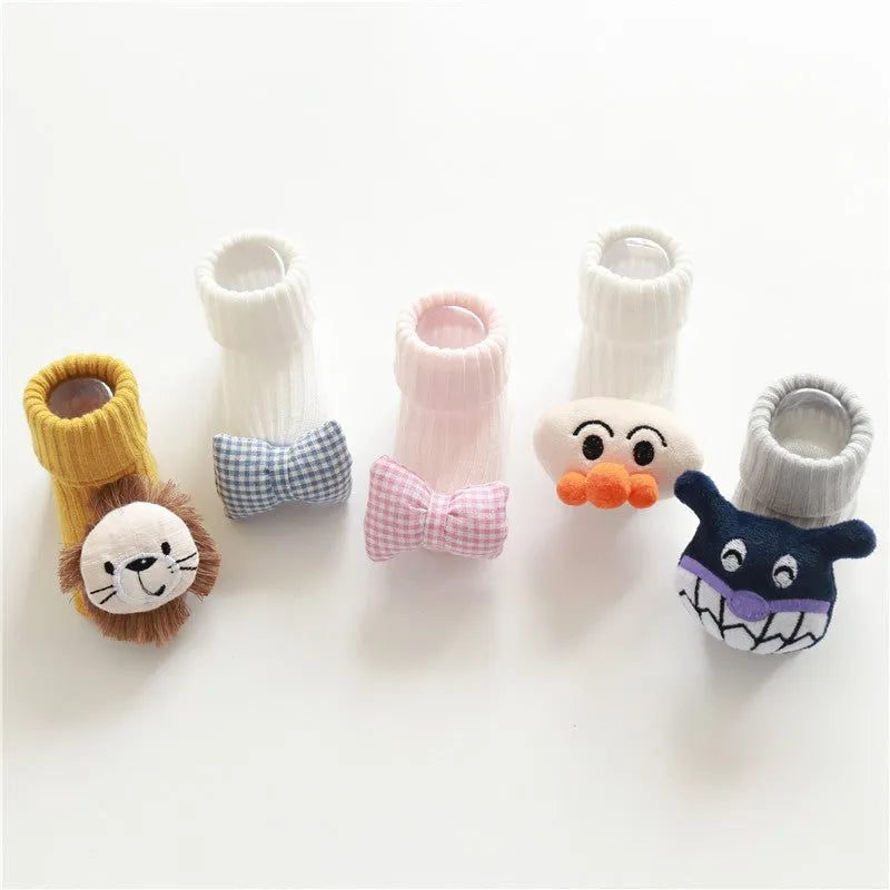 Cotton baby floor socks in assorted colours and patterns including bows, stars, and animal designs.