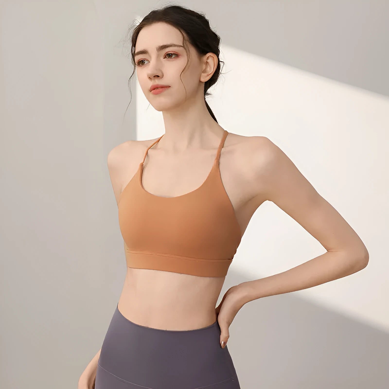 Women's high-strength nylon sports vest for running and yoga in black colour with double-shoulder straps.