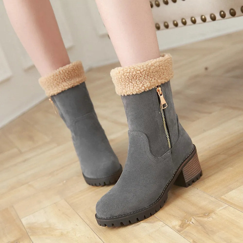 Snow boots in black, grey, green, and orange colours with a plush lining and rubber insole.