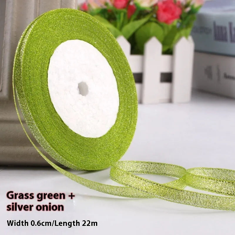 Roll of narrow 0.6cm wide polyester gift wrapping ribbon in an assorted colour, showing 22 metre length.