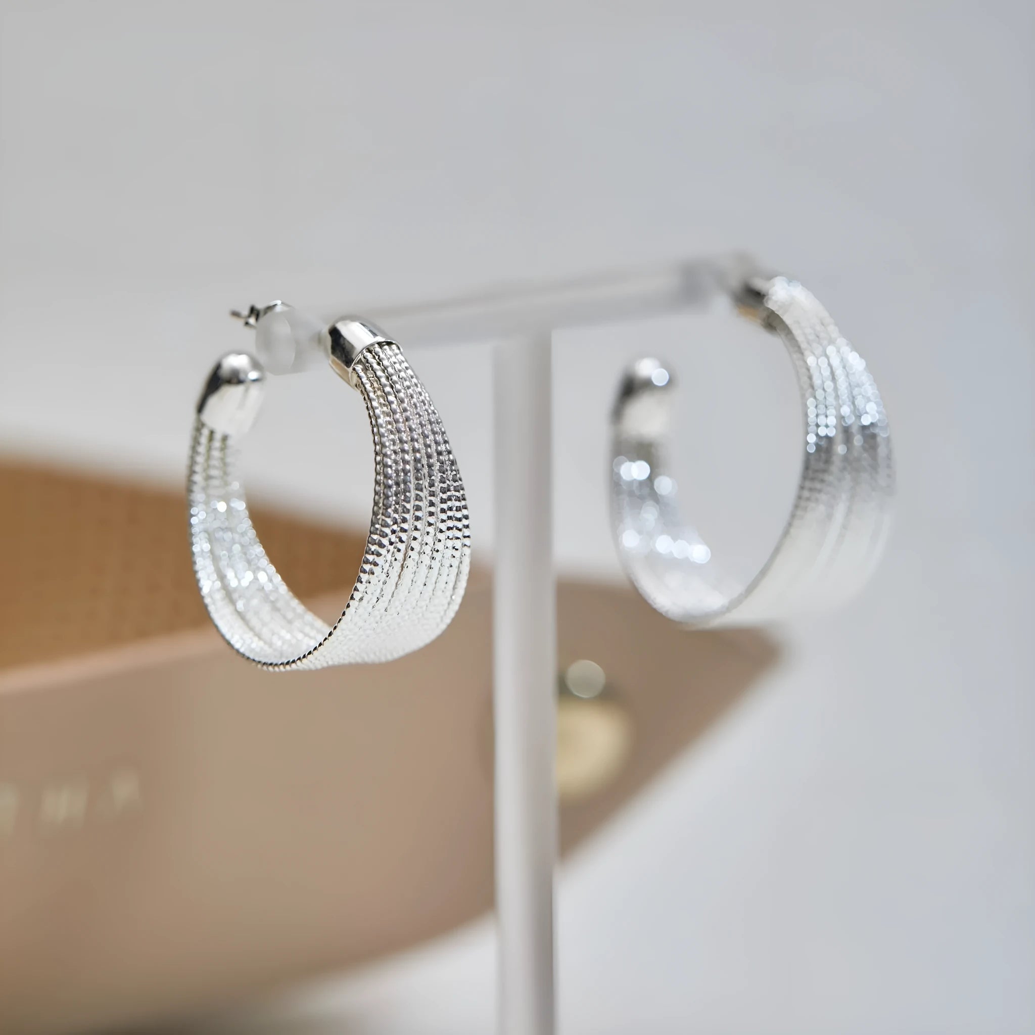 Multi-layer geometric copper earrings with electroplated gold or silver finishes, available as stud or clip styles