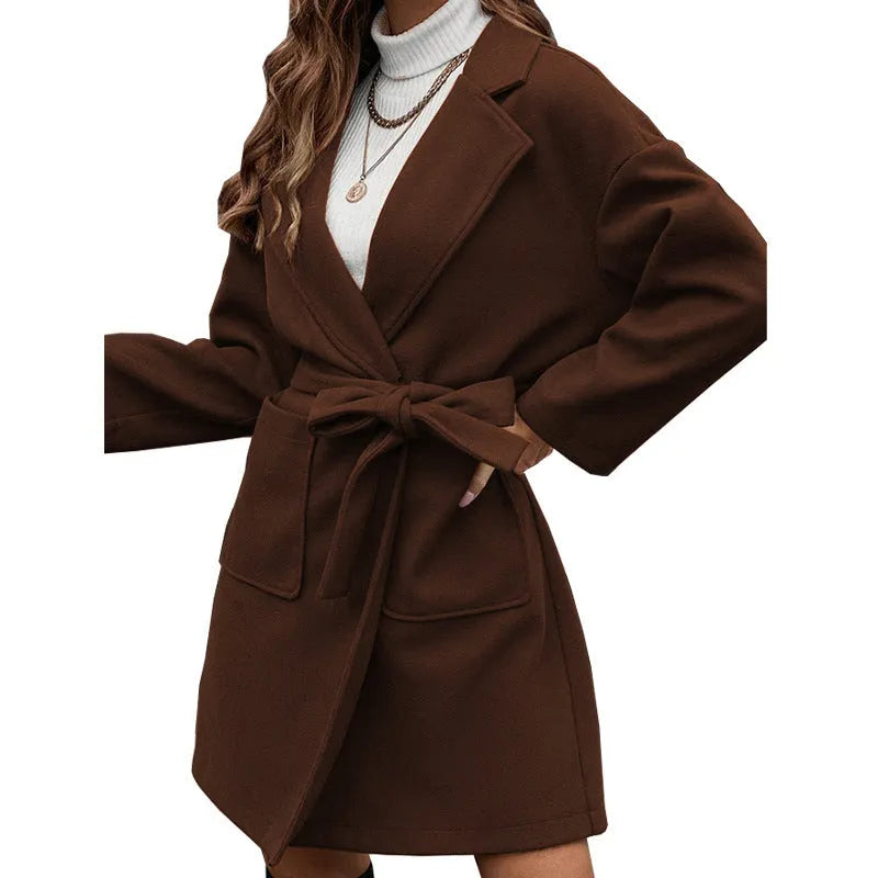Minimalist long sleeve casual coat with lapel buttons and a split belt in a loose Japanese Korean style.