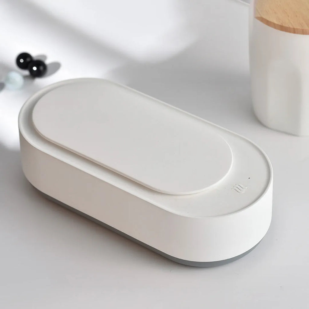 White portable ultrasonic cleaning machine with stainless steel tank and touch button.