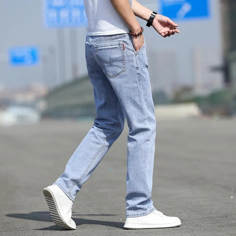 Men's smoky grey straight leg jeans with low waist design and zipper fly closure