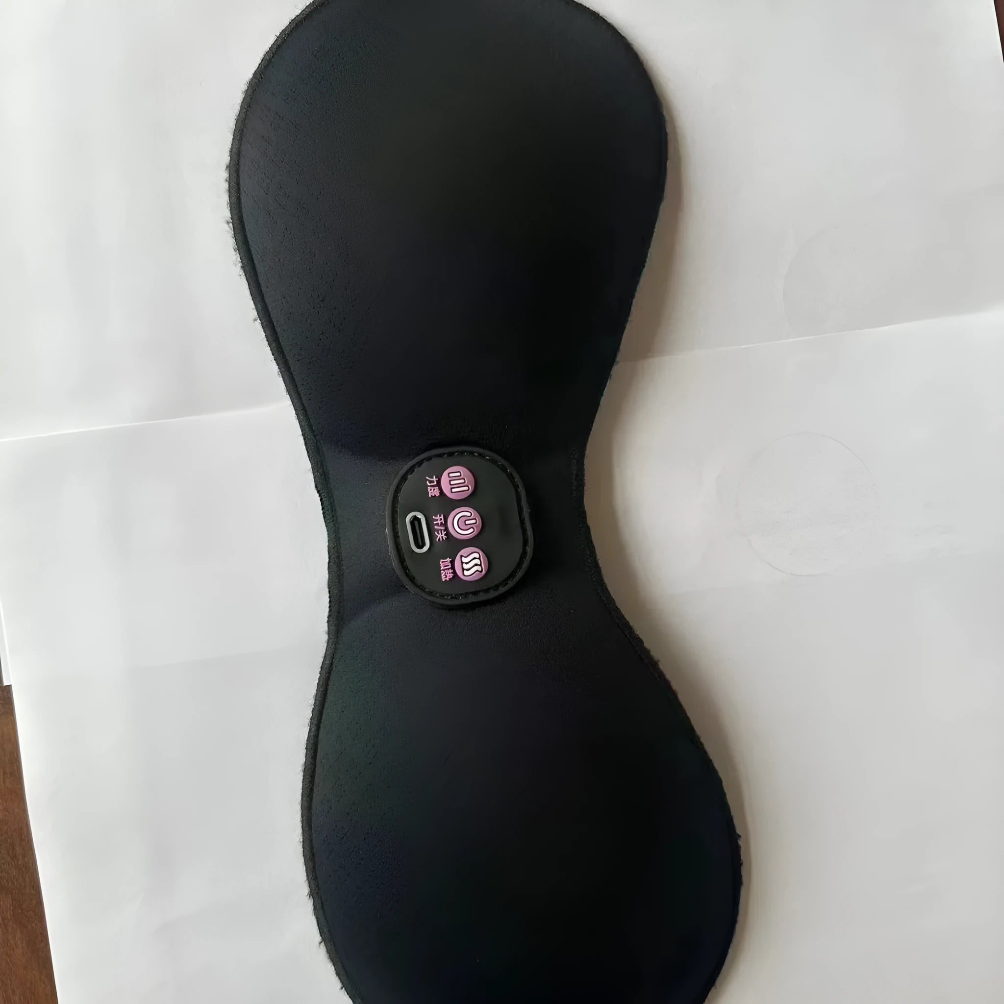 Black electric massage bra inner cushion with adhesive chest stickers and a 3-key control panel.