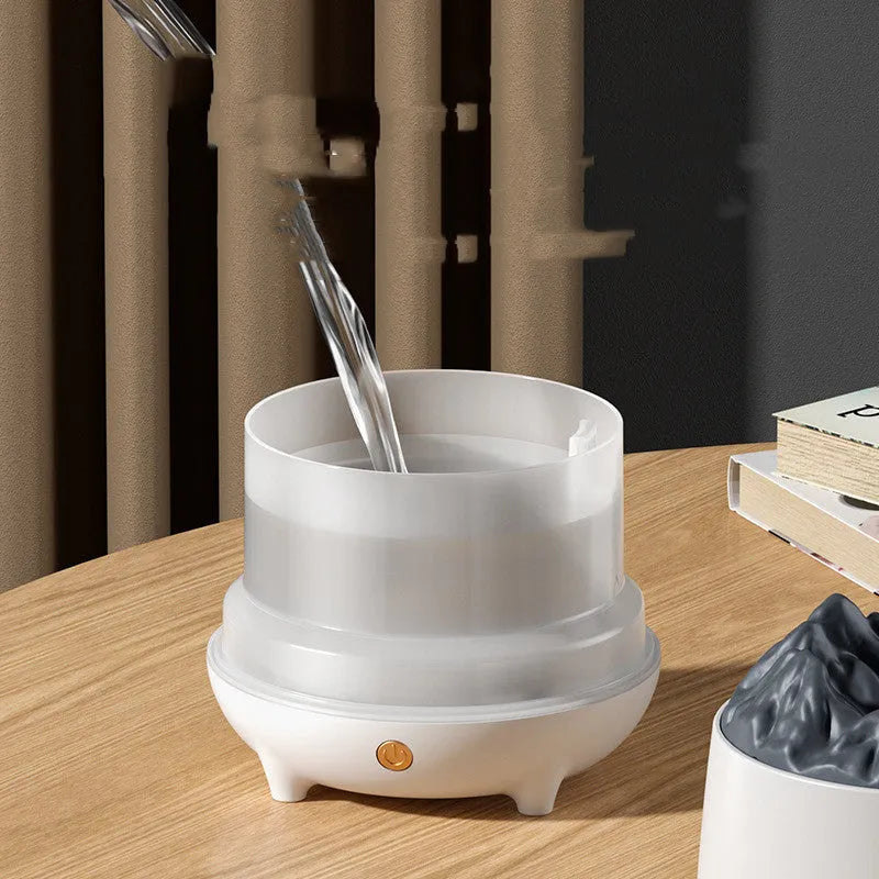 Volcano-shaped white humidifier with USB cable and mist rising from single outlet