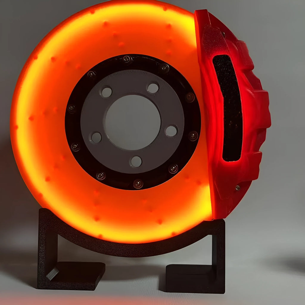 Blue brake disc LED night light with bracket on desk, showing 24cm disc and touch switch