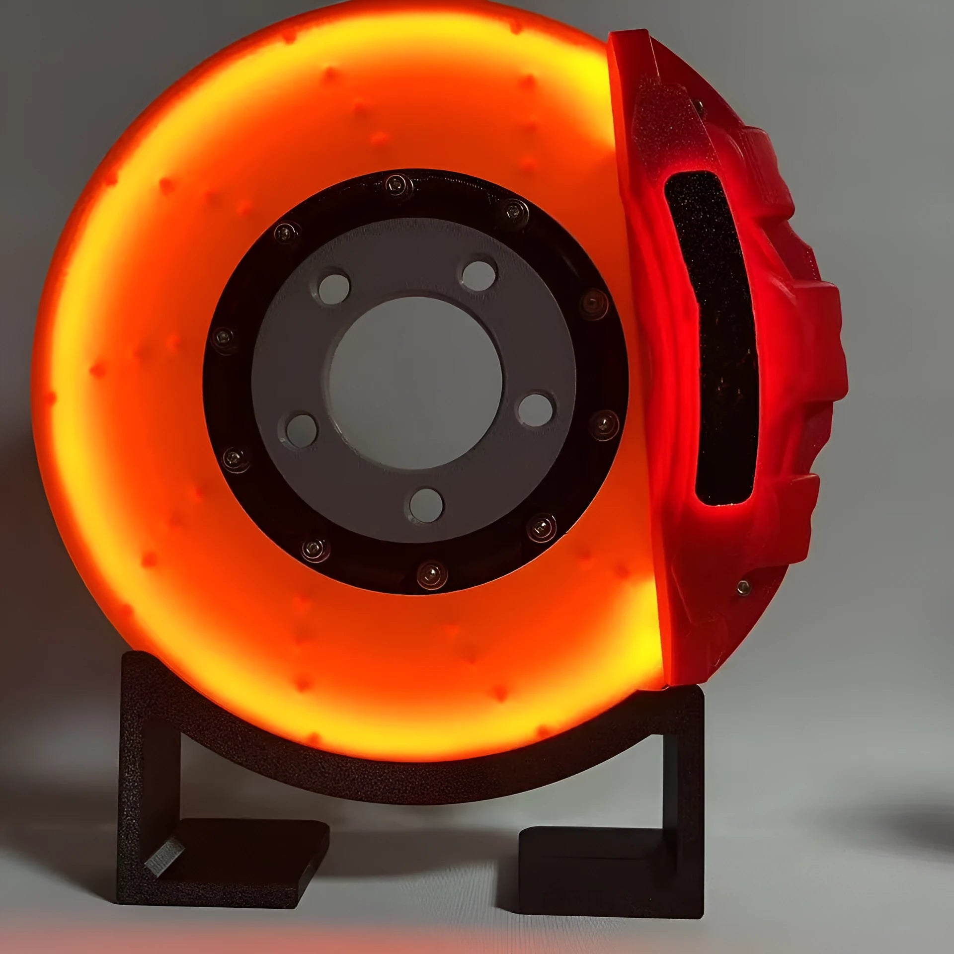 Blue brake disc LED night light with bracket on desk, showing 24cm disc and touch switch