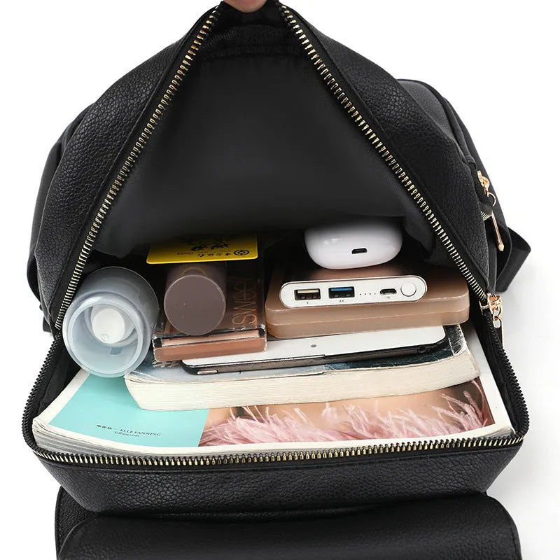 Casual women's leather backpack in black with textured pu finish and three-dimensional pocket design