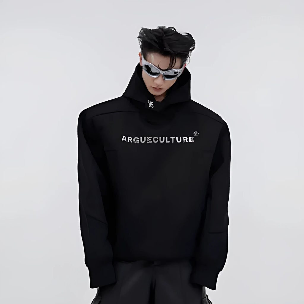A man's loose black hooded sweater with heavy shoulder pads and a metallic three-dimensional printed design on the front.