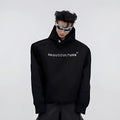 A man's loose black hooded sweater with heavy shoulder pads and a metallic three-dimensional printed design on the front.
