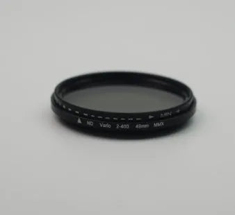 Set of circular camera lens filters in multiple sizes including ND-2, ND-4, ND-8, and ND-400 neutral density filters.