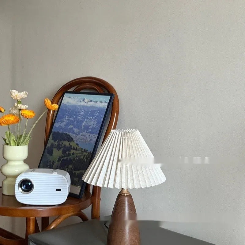 Nordic retro ceramic table lamp with pleated fabric shade and remote control on a bedside table