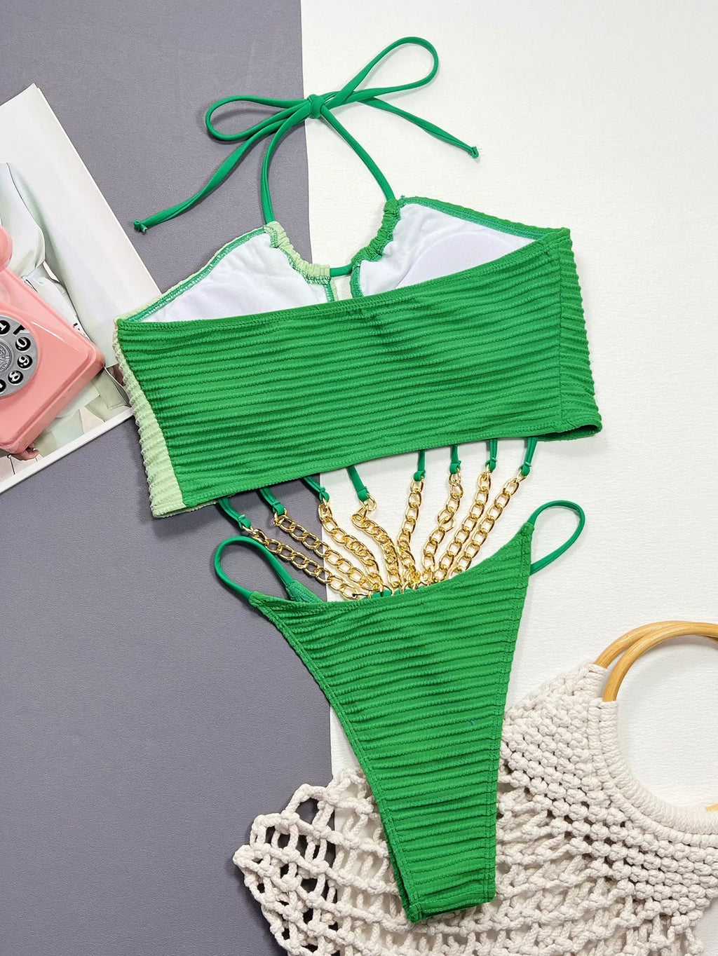 Green women's one-piece swimsuit with a hollow cut-out design detail on the front.