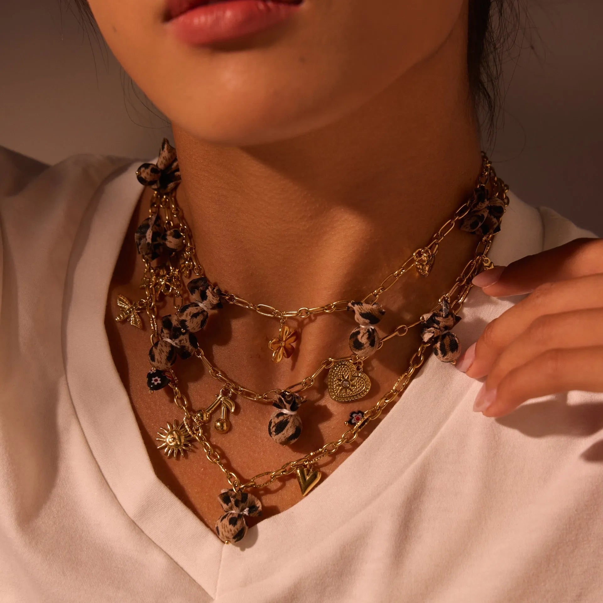 Women's stainless steel necklace with geometric leopard pendant featuring love heart and floral details on adjustable chain