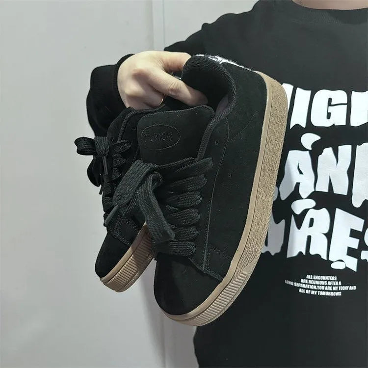 Black retro low-top sneakers with lace-up front, waterproof platform, and round toe design