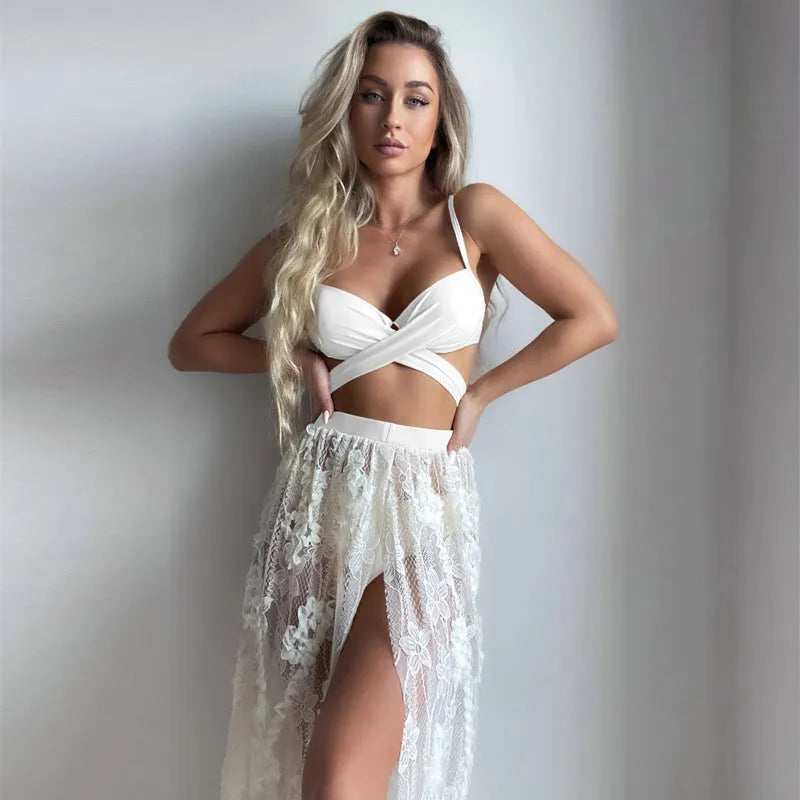 Women's creamy white backless push-up bikini three-piece set with a skirt on a neutral background.