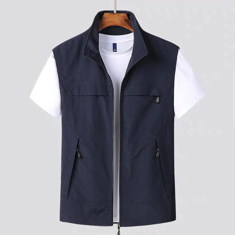 Man wearing a khaki multi-pocket hooded casual vest with a front zip and patch pockets.