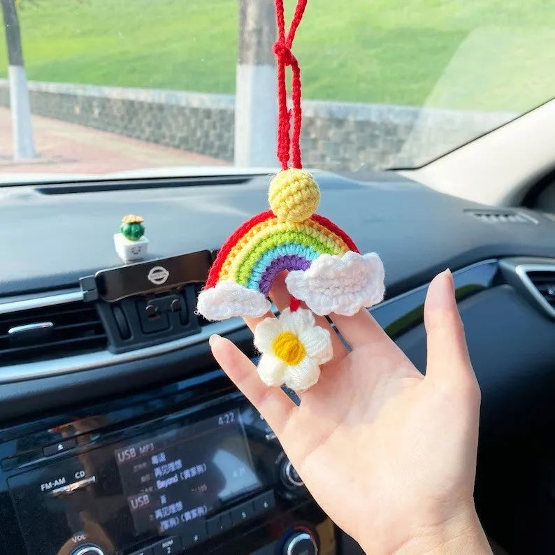 Handmade crocheted avocado-shaped car pendant in wool, shown in three colour variations.