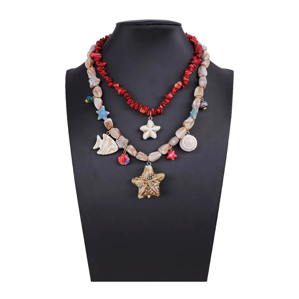 Gold marine life clavicle chain with conch shell and starfish pendant on display