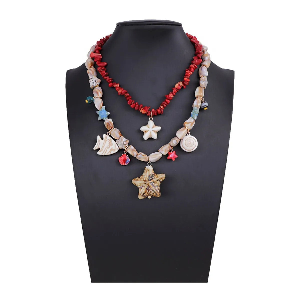 Gold marine life clavicle chain with conch shell and starfish pendant on display