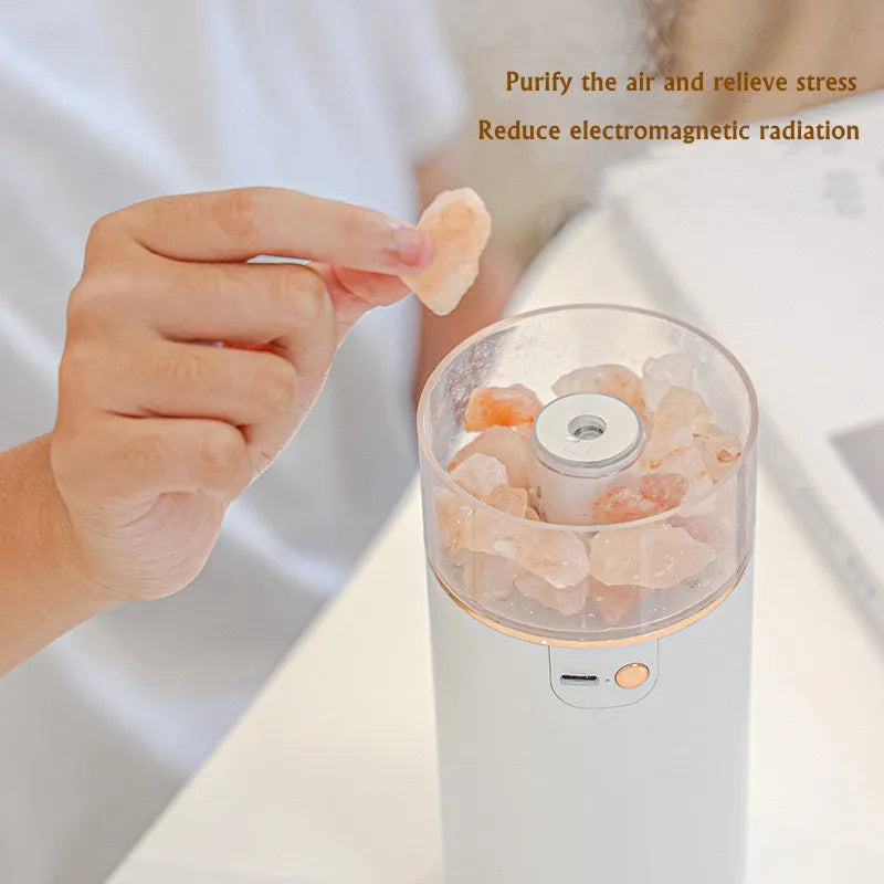 Ultrasonic aromatherapy diffuser humidifier with natural crystal salt stone and LED lamp in blue, showing mist and light