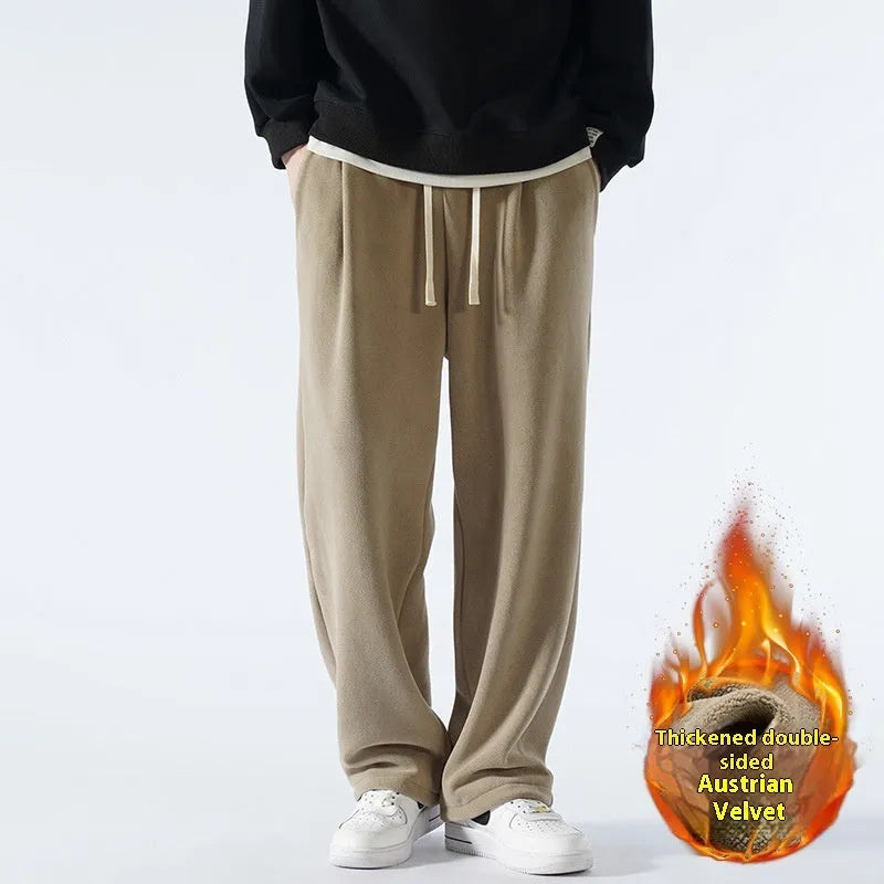 Men's apricot coloured loose-fit fleece-lined winter sports trousers with a drawstring waist laid flat.