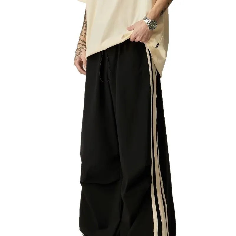 Man wearing black high-waist wide leg climbing pants made from polyester for casual leisure wear.