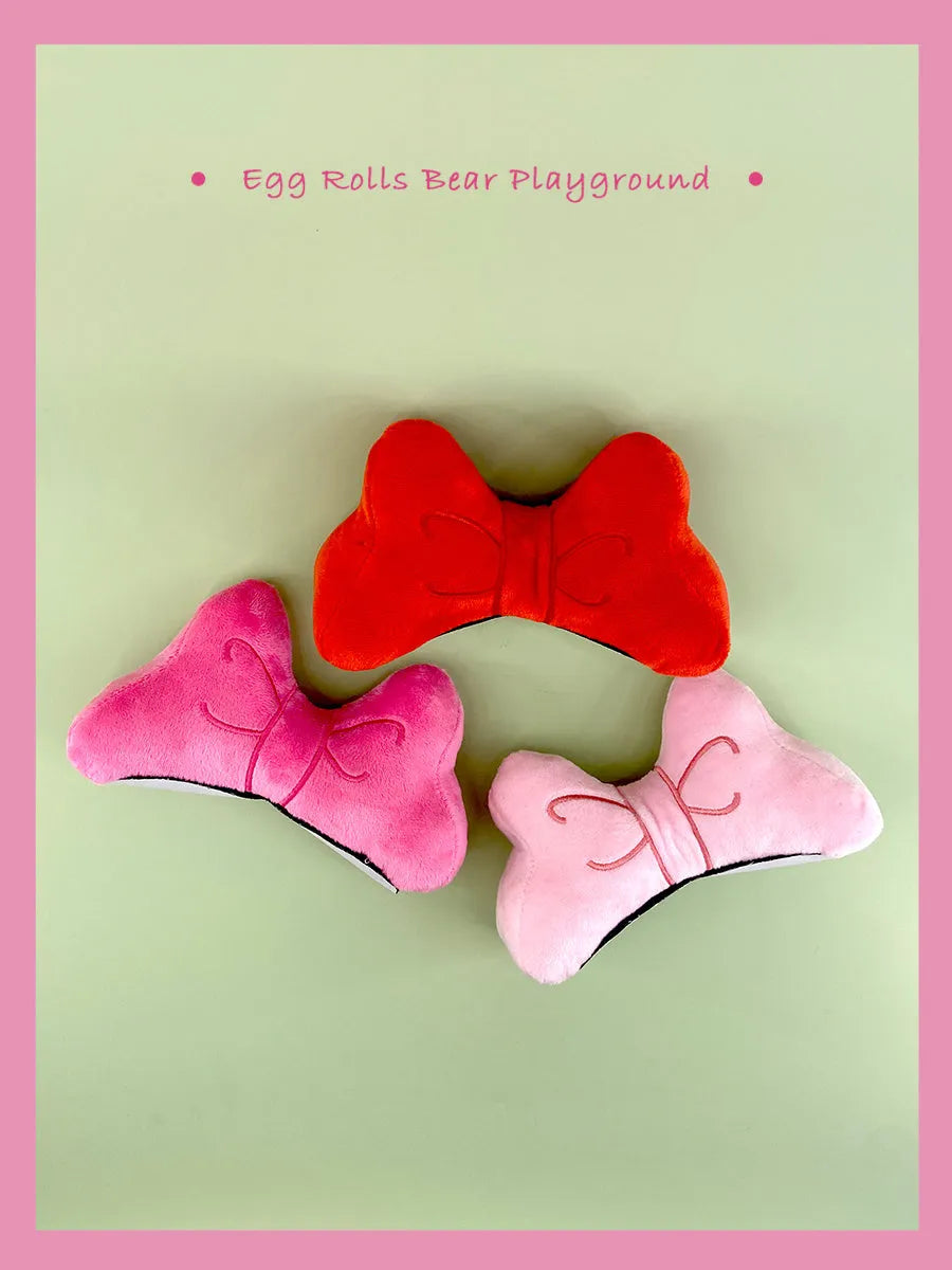 Plush velvet bow tie decoration for attaching to a motorcycle or ski helmet.