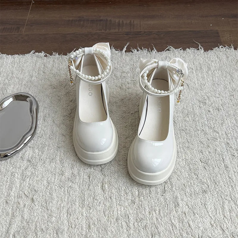 Women's beige chunky heel Mary Jane pumps with a round toe and shallow cut on a white background.