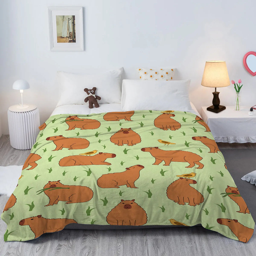 Multicolored flannel blanket with bird and capybara combined pattern on a sofa