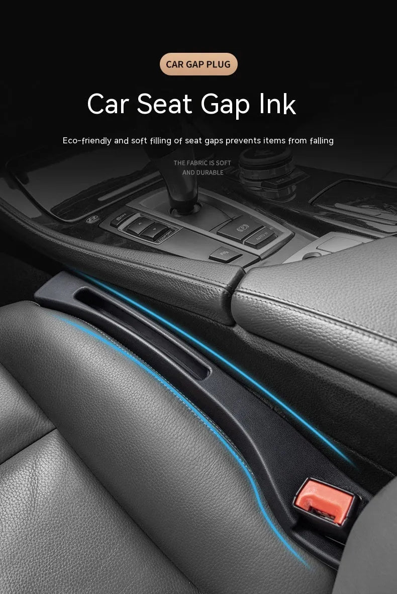 Black plastic car seat gap storage box with handle inserted between car seats.