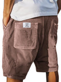 Men's grey corduroy shorts with multiple pockets and an embroidery mark on the leg, shown on a hanger.