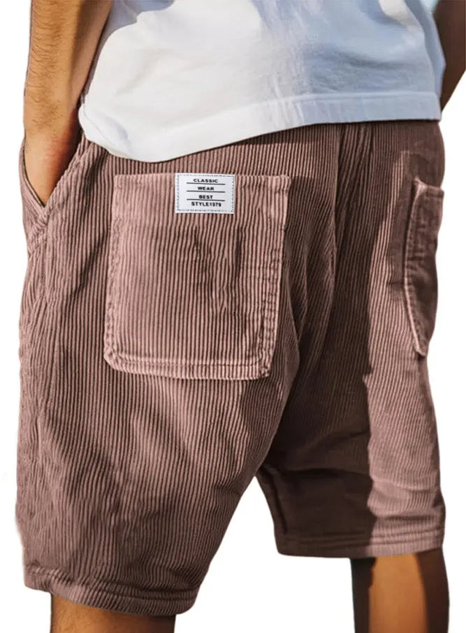 Men's grey corduroy shorts with multiple pockets and an embroidery mark on the leg, shown on a hanger.