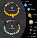 Twelve zodiac sign bracelets with natural stone beads and silver charm symbols on elastic cords