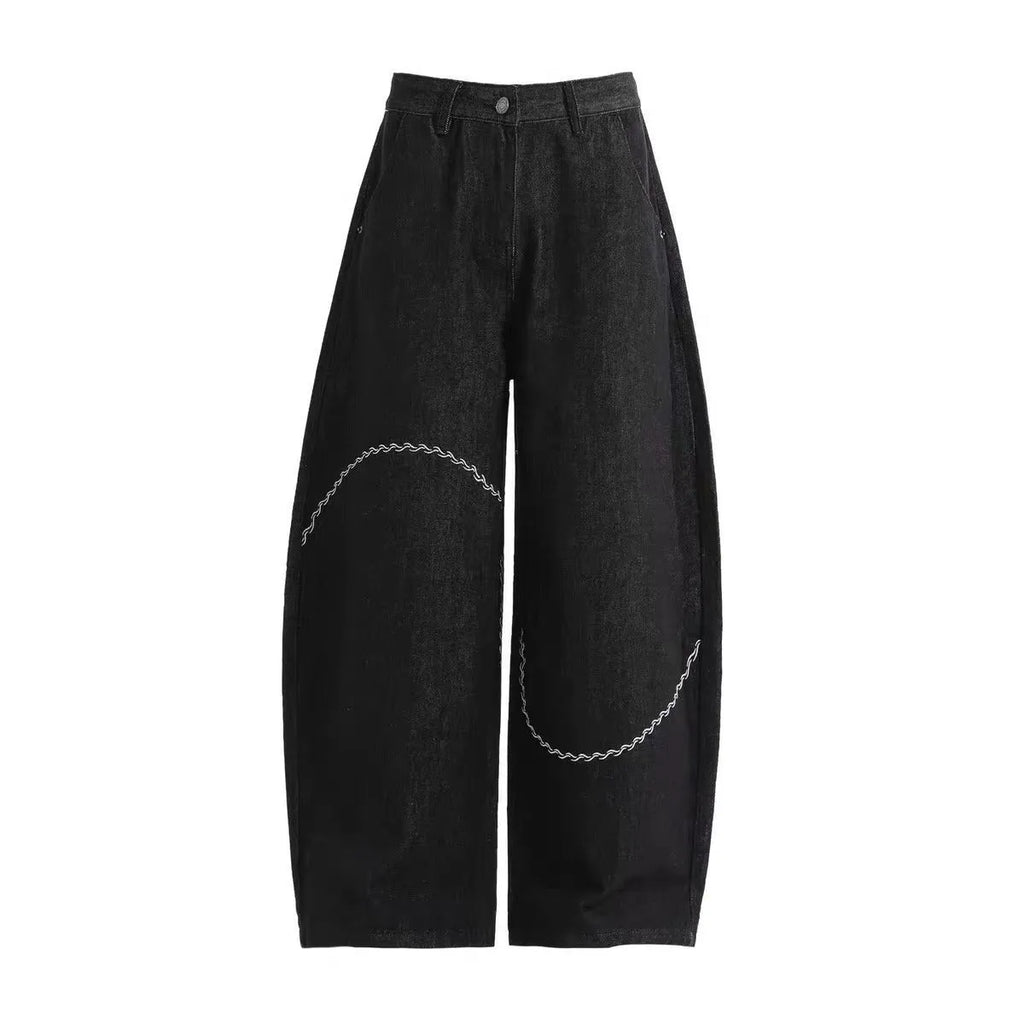 Black straight-leg men's trousers with a mid-waist and zip fly on a hanger.