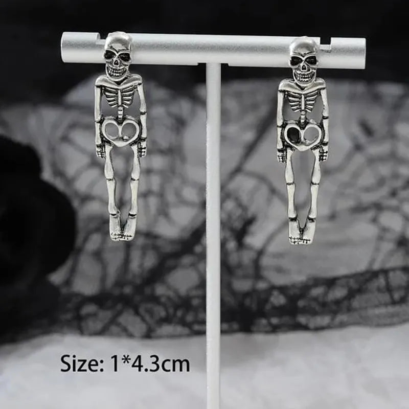 Gold and silver skull detachable stud earrings with skeleton design on white background