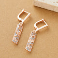 A pair of rectangular two-tone hollow stud earrings with a geometric shape and electroplated finish.