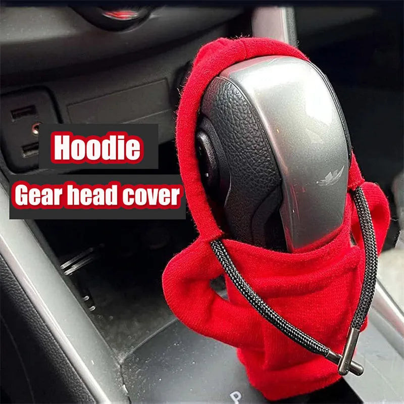 Universal cotton gear knob cover hoodie in blue with adjustable drawstring on a car shift knob