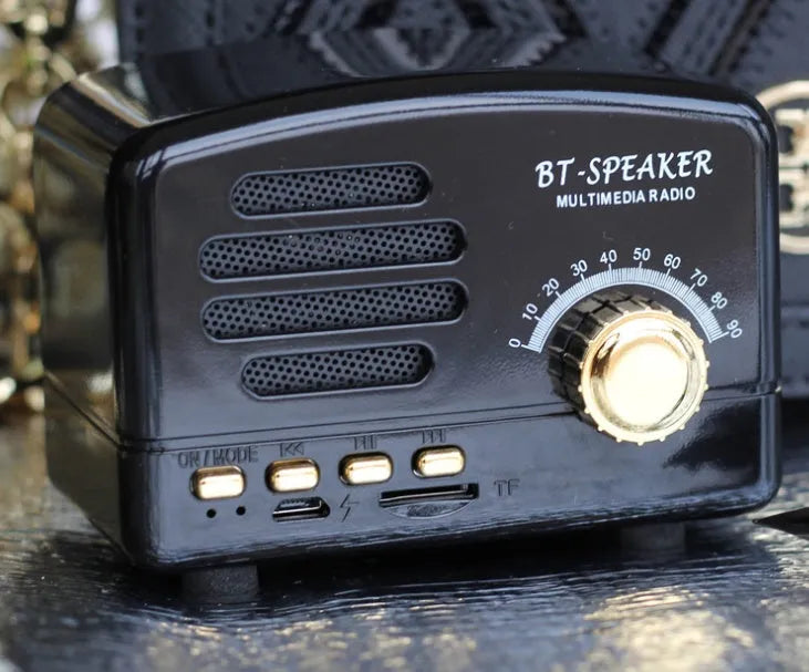 Vintage wood finish Bluetooth speaker in black colour on a wooden surface
